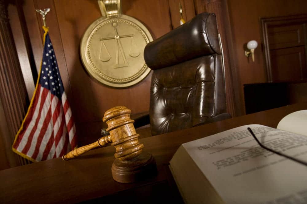 Image is of a courtroom with a judge's bench and gavel, concept of a family law attorney representing clients during family court proceedings.