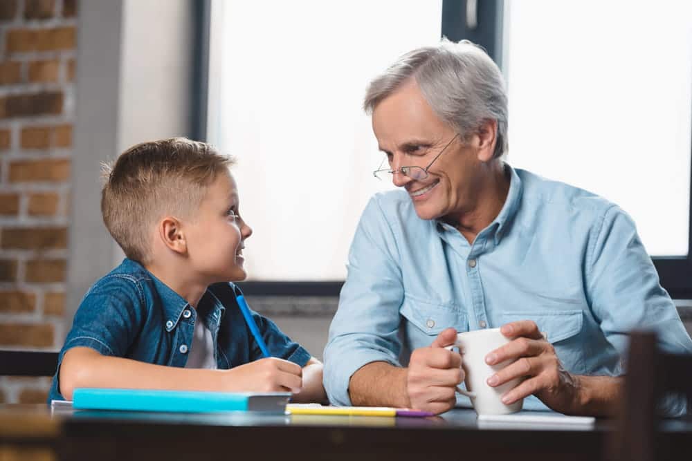 Image is of a grandparent talking with a child during family time, concept of a grandparents' rights attorney.