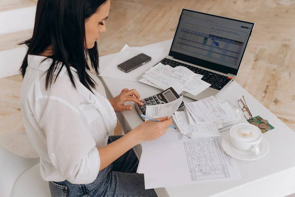 Image is of a person reviewing financial records, receipts, and account documents, concept of a high-net-worth divorce attorney analyzing complex financial information and marital assets.