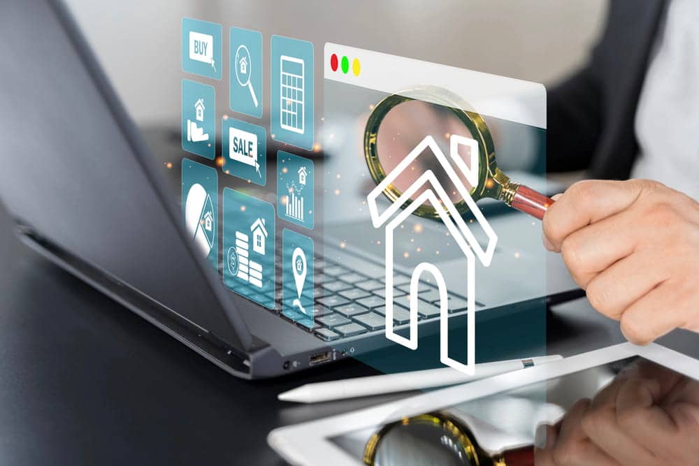 Image is of a professional reviewing digital real estate information, concept of a high-net-worth divorce attorney identifying and valuing marital assets.