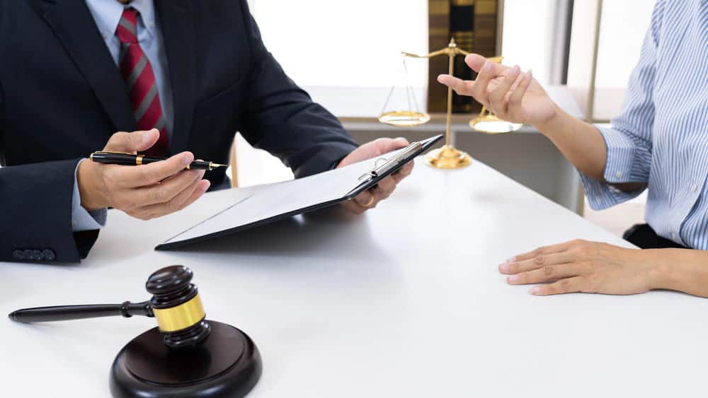 Image is of a lawyer meeting with a client in an office, concept of a legal separation attorney providing guidance on separation rights and legal options.