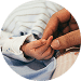 Adult hand holding a sleeping infant's hand