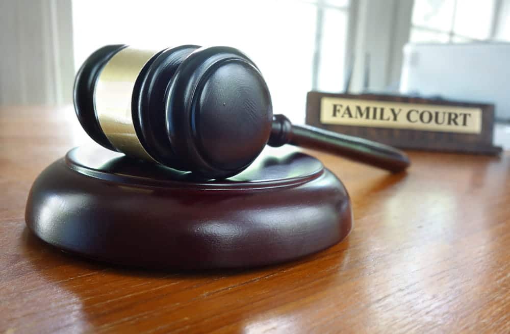 Image is of a judge's gavel in front of a Family Court sign, concept of modifying a child custody order through the North Carolina court process.