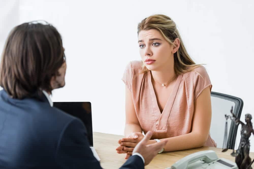 Image is of a client discussing concerns with a lawyer during a consultation, concept of an alienation of affection attorney evaluating a potential claim.