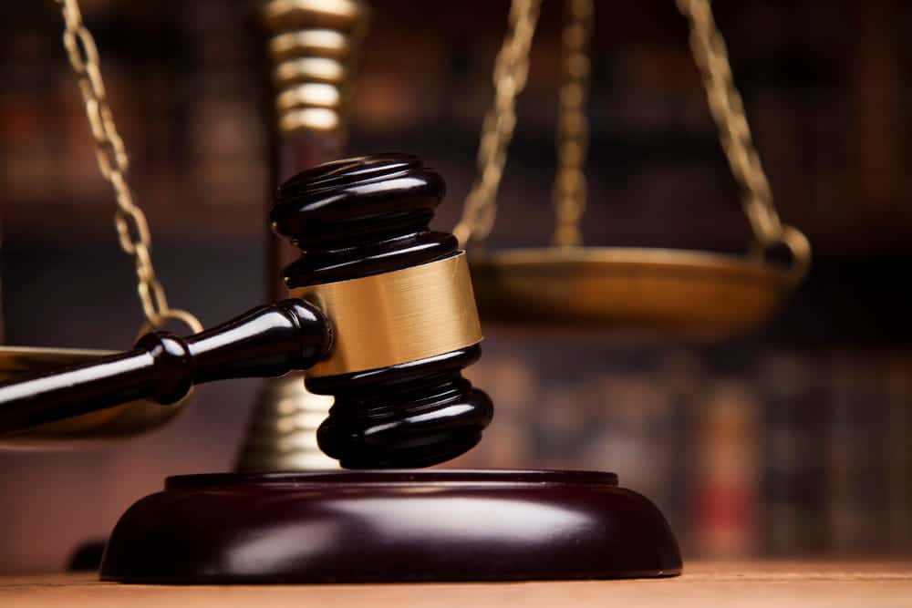 Image is of a courtroom gavel and scales of justice, concept of a criminal conversation attorney pursuing a civil claim in court.