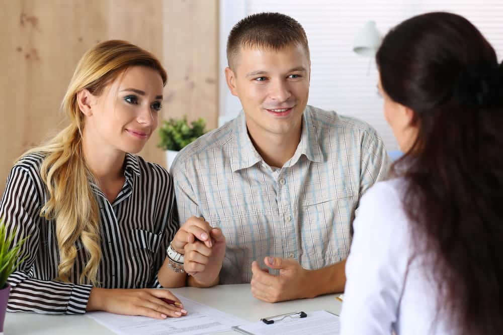 Image is of parents meeting with a family professional to discuss parenting arrangements, concept of parenting coordinator.