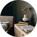 Small model house on a desk beside stacked documents