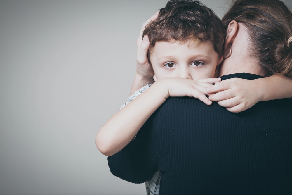 Image is of a mother comforting her young child, concept of a mothers' rights attorney helping with family law concerns
