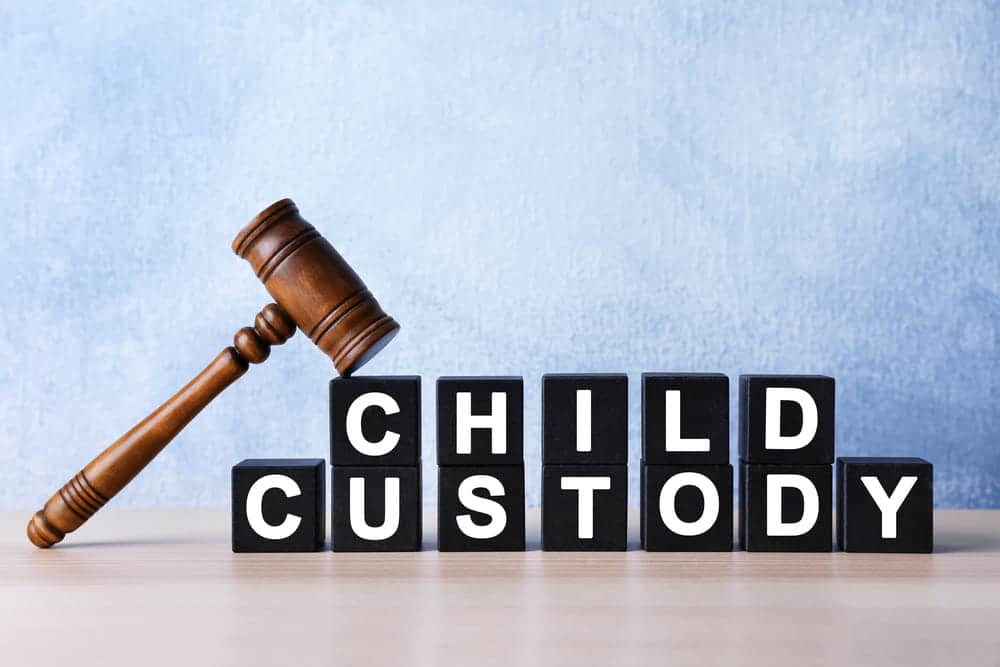 Image is of a judge’s gavel beside child custody blocks, representing court decisions involving parenting arrangements.