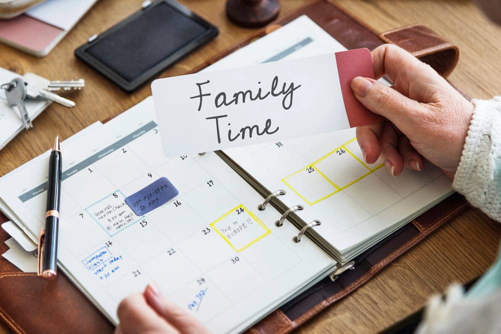 Image is of a family calendar and family time card, representing scheduling arrangements in a parenting plan.